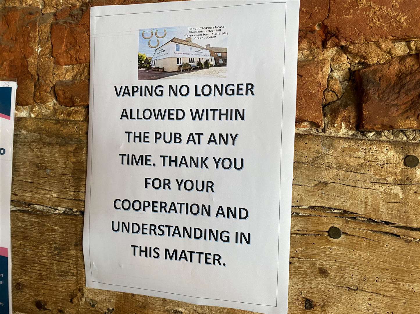One of the posters warning of the new rule change on the pub wall
