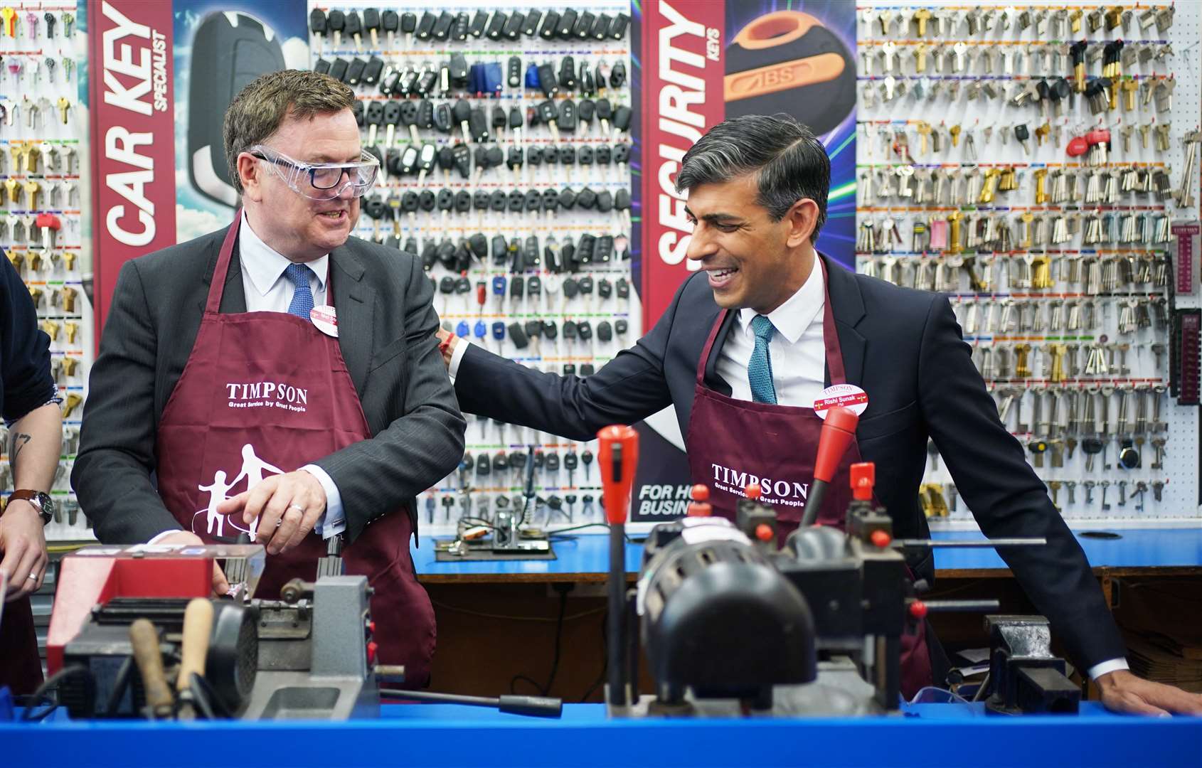 The Prime Minister, right, with Work and Pensions Secretary Mel Stride visiting a Timpson branch after giving his policy speech on welfare reform (Yui Mok/PA)