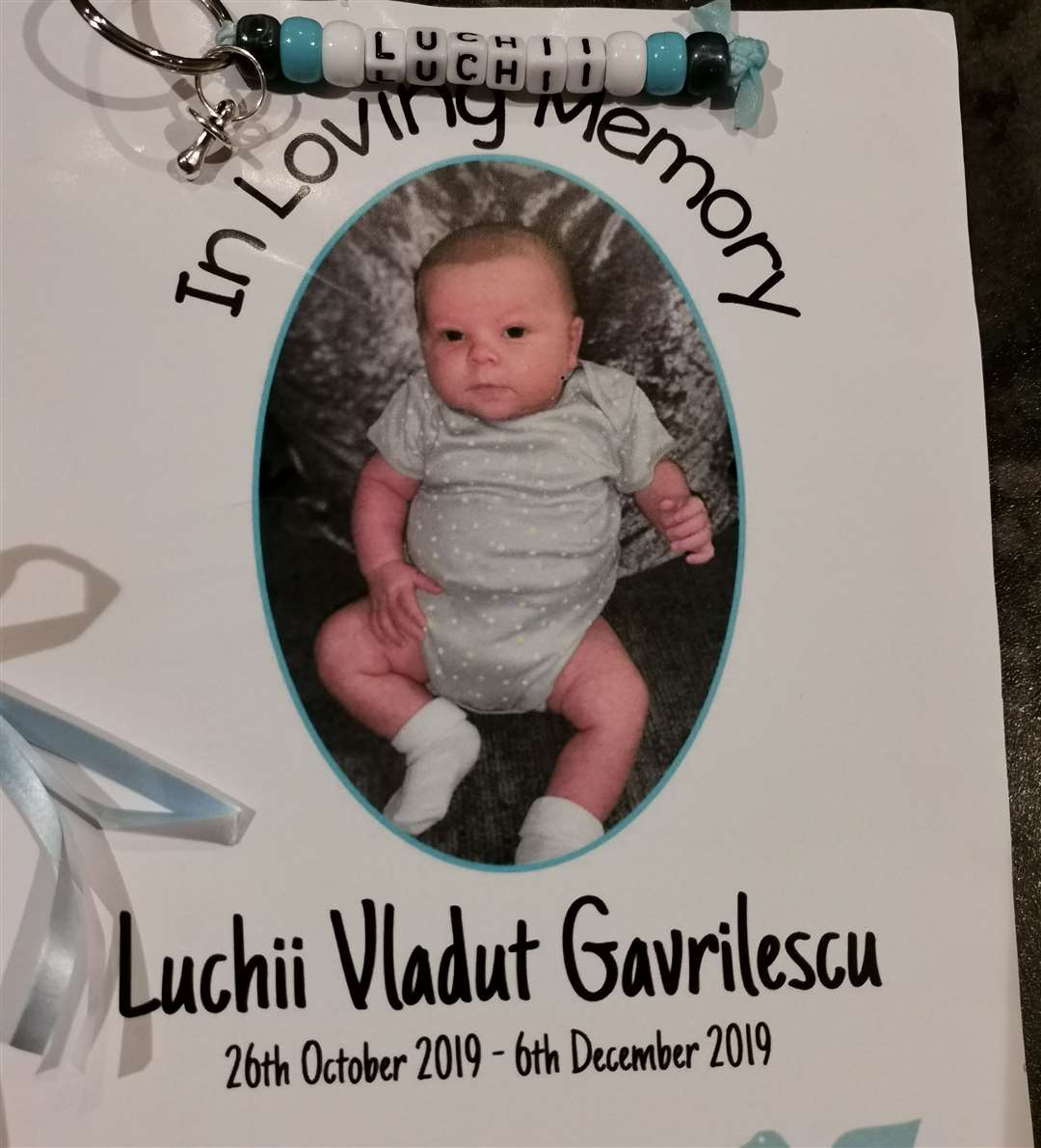 The order of service of Luchii's funeral and keyring handed out to loved ones