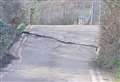 Huge crack appears on road next to busy railway line