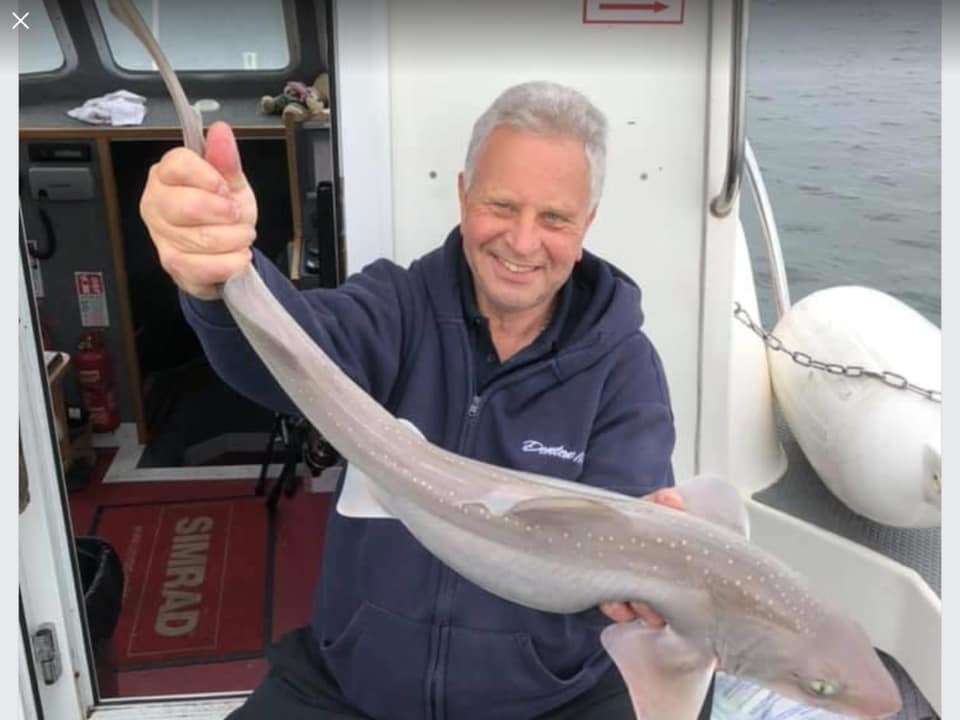 Bill East, from West Kingsdown, holding a smooth hound shark he caught on the Kent coast
