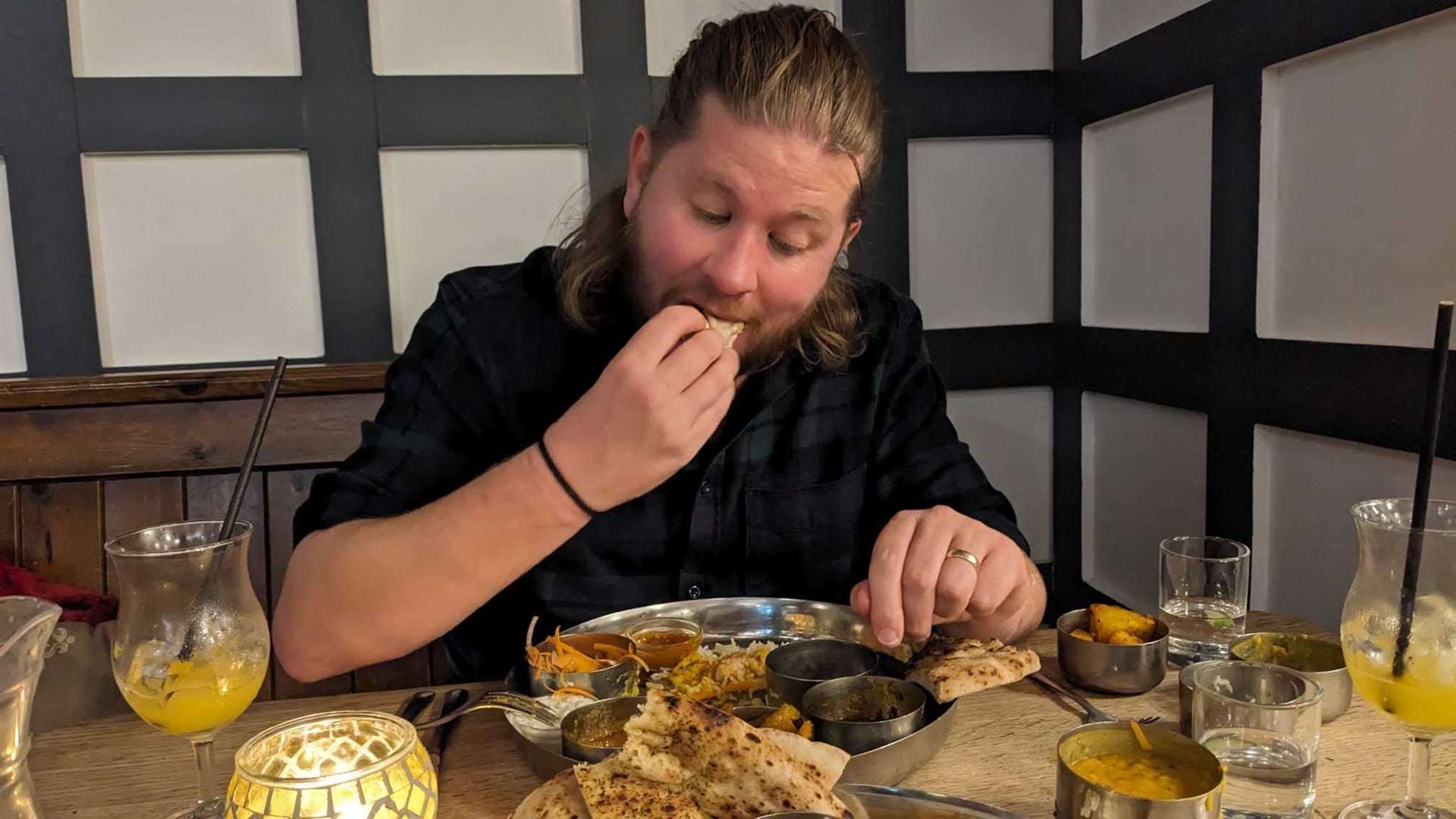 Reporter Rhys Griffiths gets stuck in to his thali