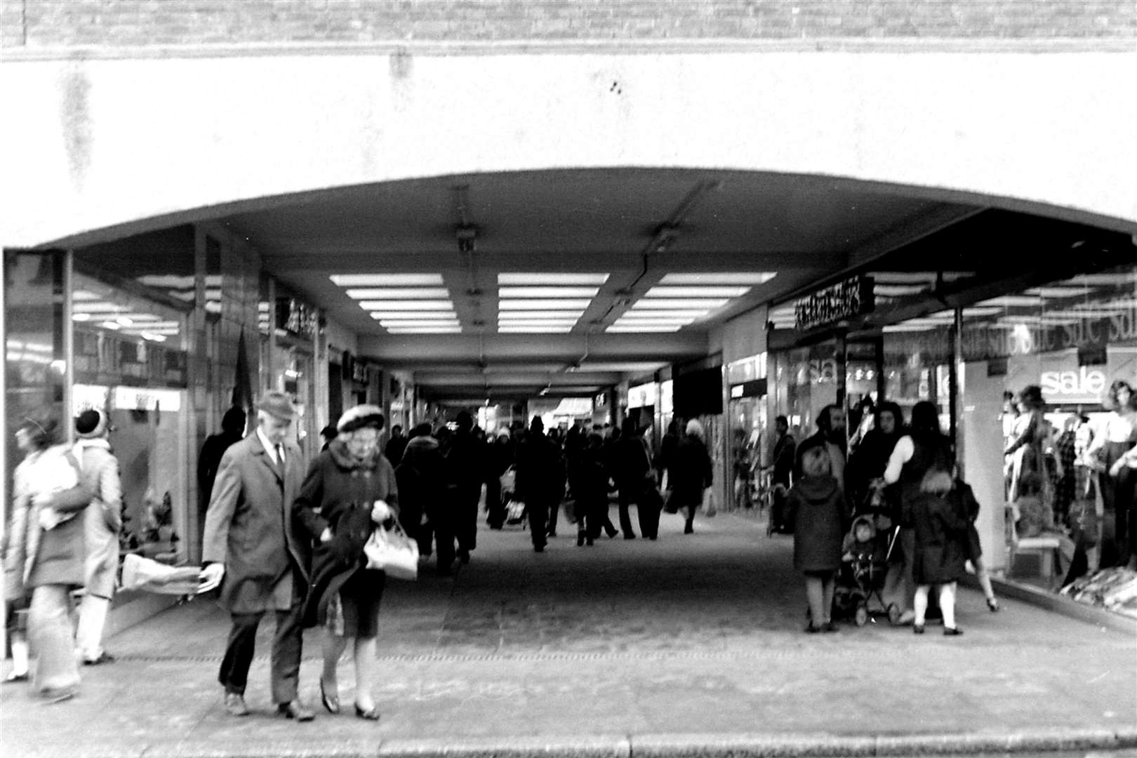 1975: The original High Street entrance to the open-aired Tufton Centre (now County Square) illustrating a bustling mall in the mid-seventies