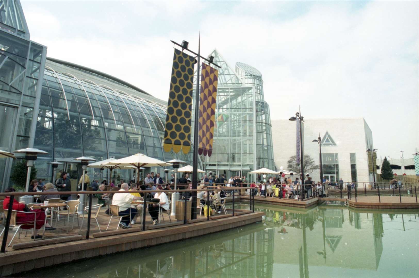 People dine outside by the water at Bluewater on its opening day in 1999