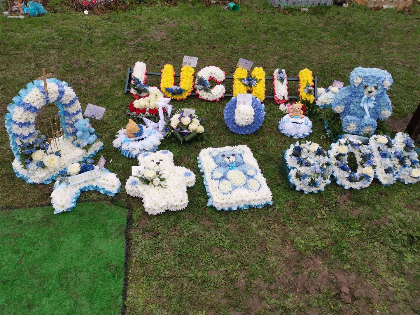 Flowers at the graveside at the funeral of little Luchii