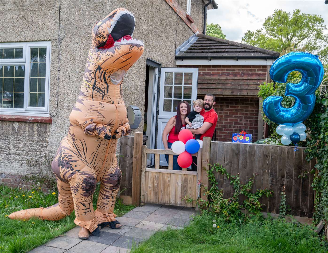 Estelle's husband dressed up as a dinosaur to celebrate neighbour Josh who was celebrating his third birthday in lockdown Photo: Estelle Thompson Photography