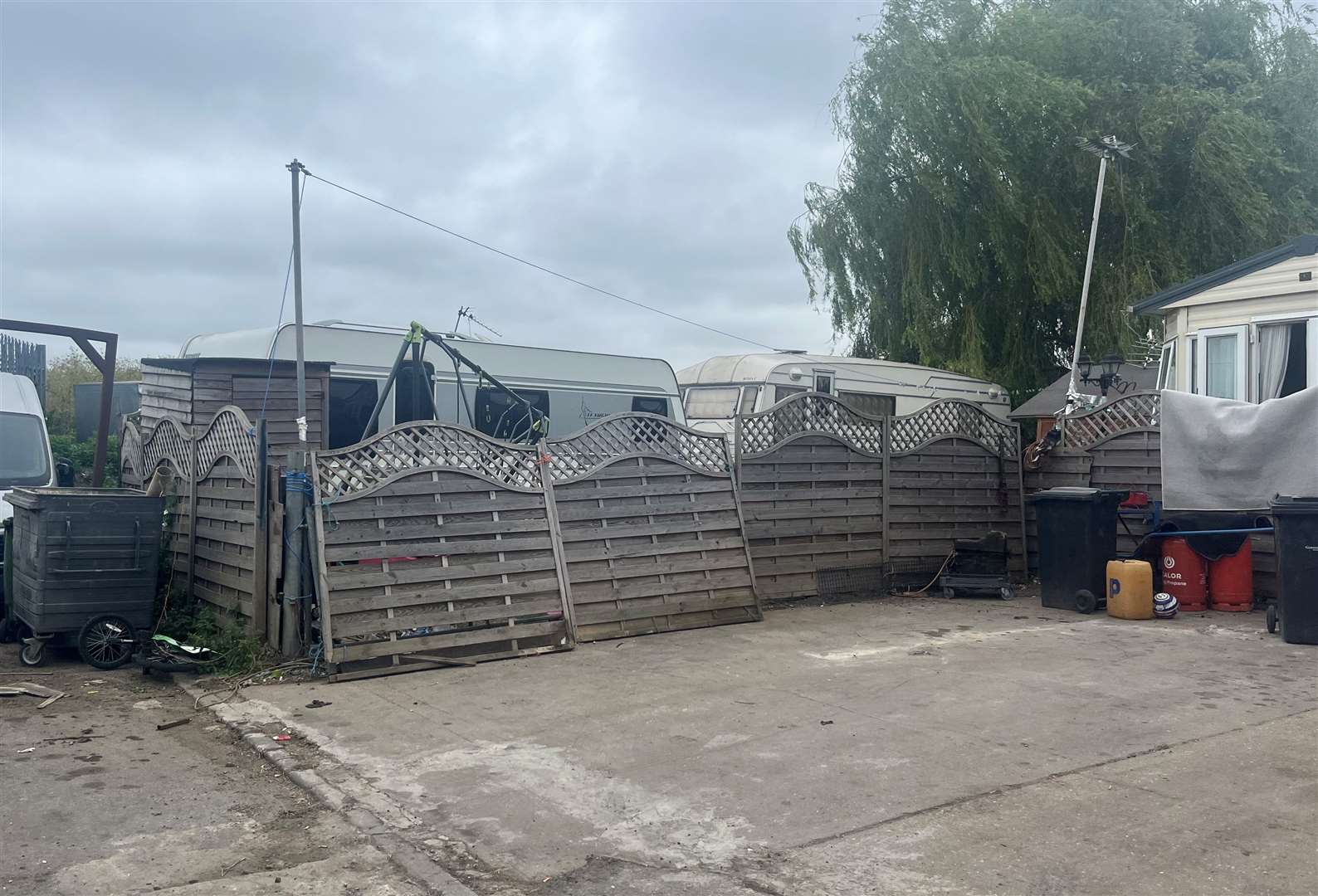 Plots are tightly next to each other, separated by fallen fences