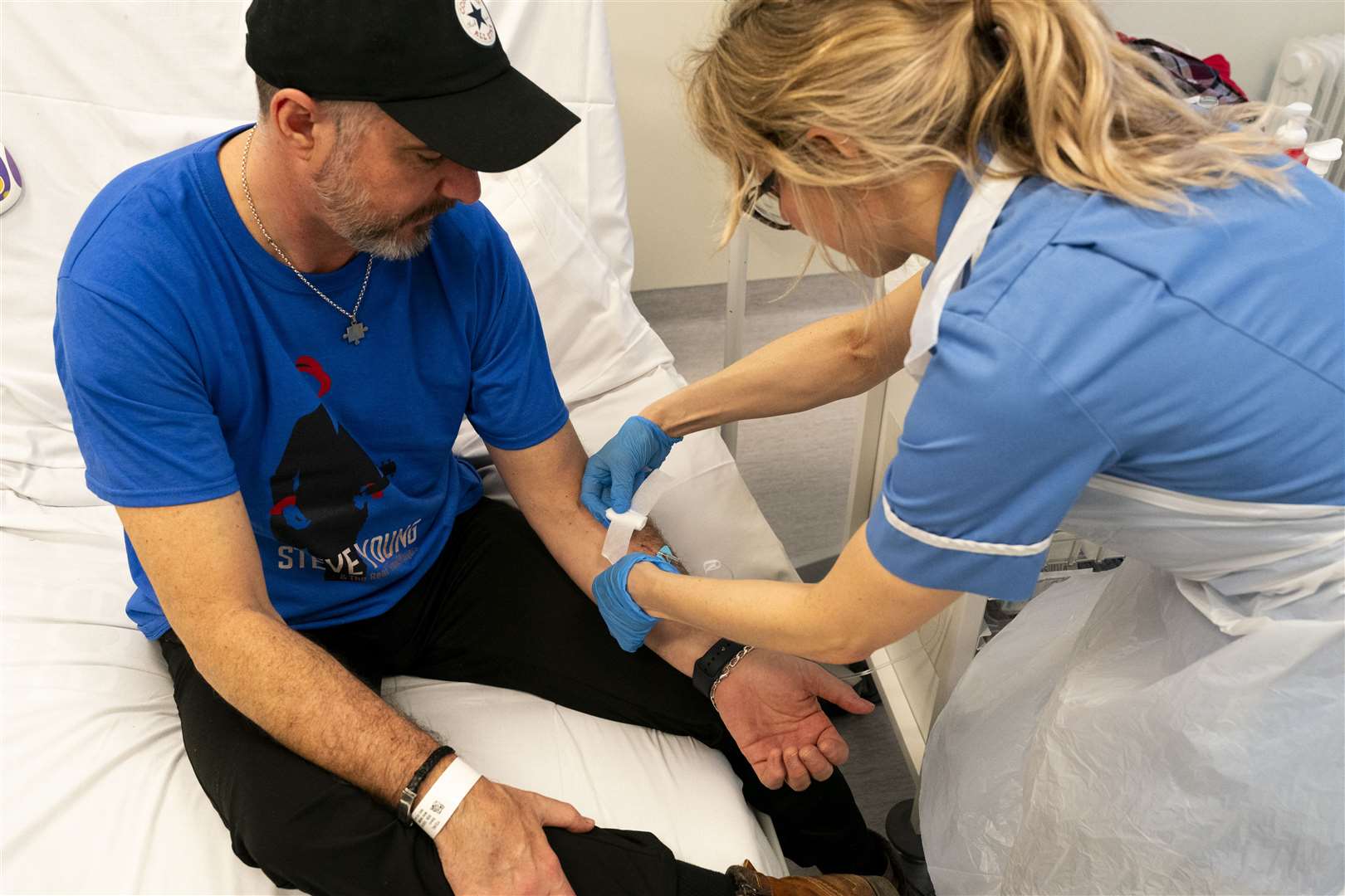 Nurse Eleanor Ferguson gives an infusion to patient Steve Young at University College London Hospital (Jordan Pettitt/PA)