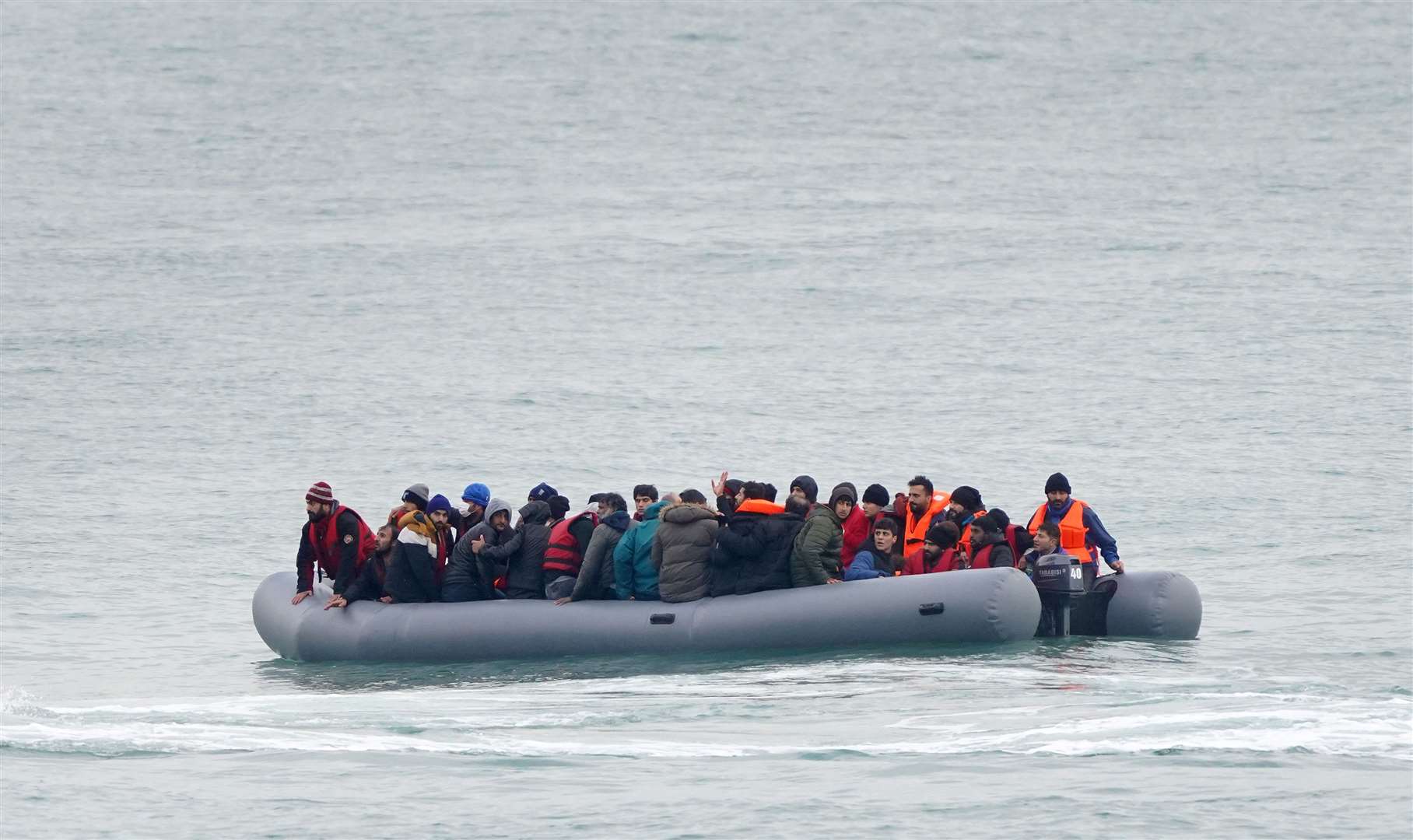 A group of people adrift in a dinghy before being rescued off the coast of Folkestone, Kent (Gareth Fuller/PA)