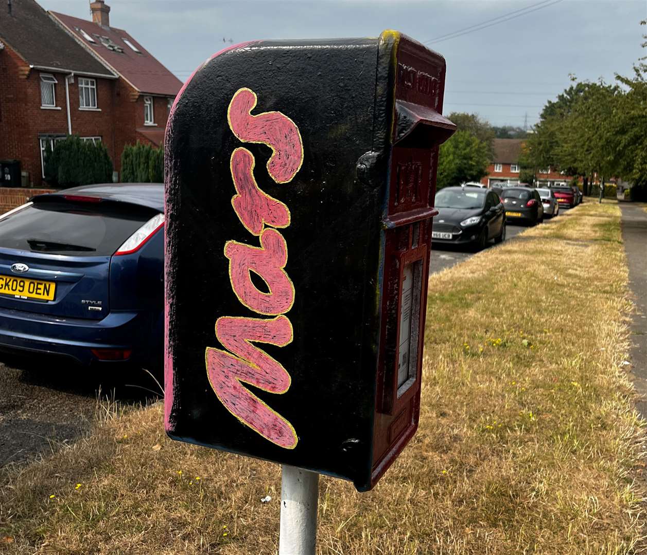 A postbox in Nightingale Grove, Temple Hill has been painted with Mars colours on one side and Twirl on the other