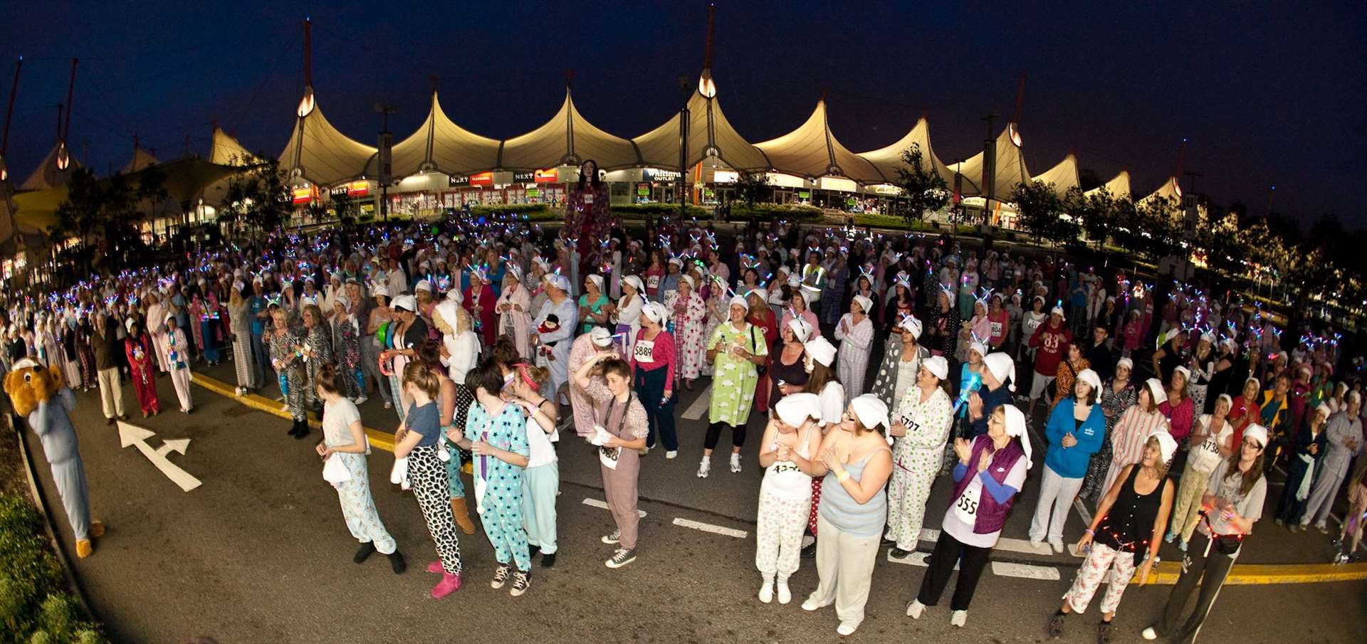 Pilgrims Hospice Pyjama Walk participants limber up for the event at the Ashford Designer Outlet in 2012