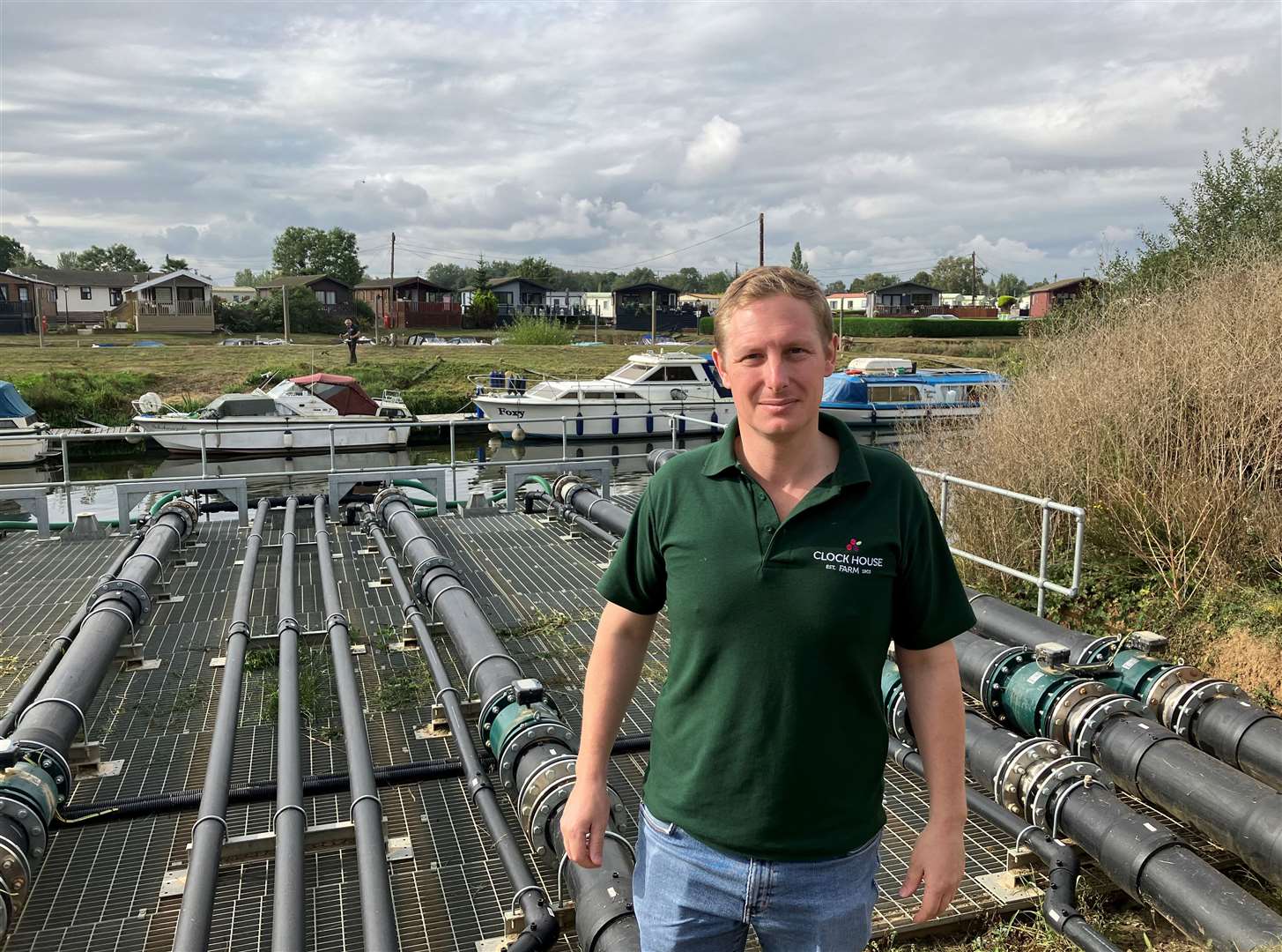 Oli Pascall with the river heat pump system by the Medway at Yalding