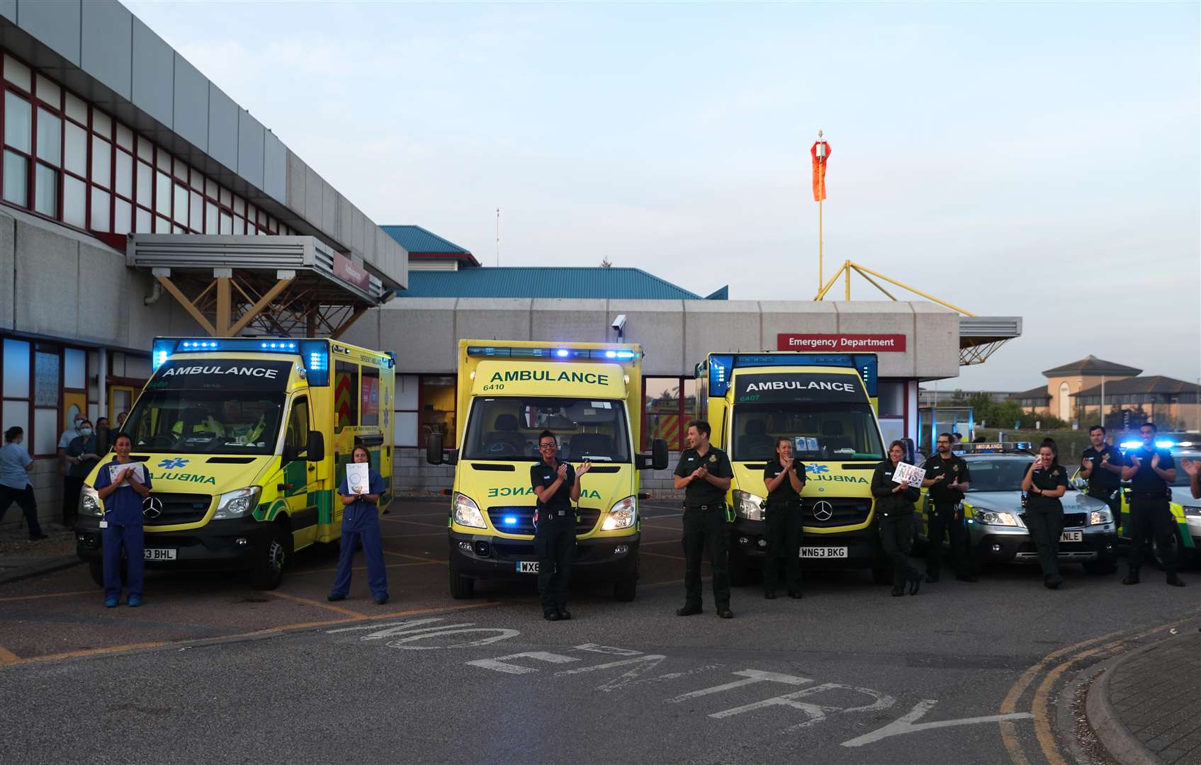 Hospital staff and paramedics outside the Royal Bournemouth Hospital to salute local heroes during Thursday’s nationwide Clap for Carers initiative (Andrew Matthews/PA)