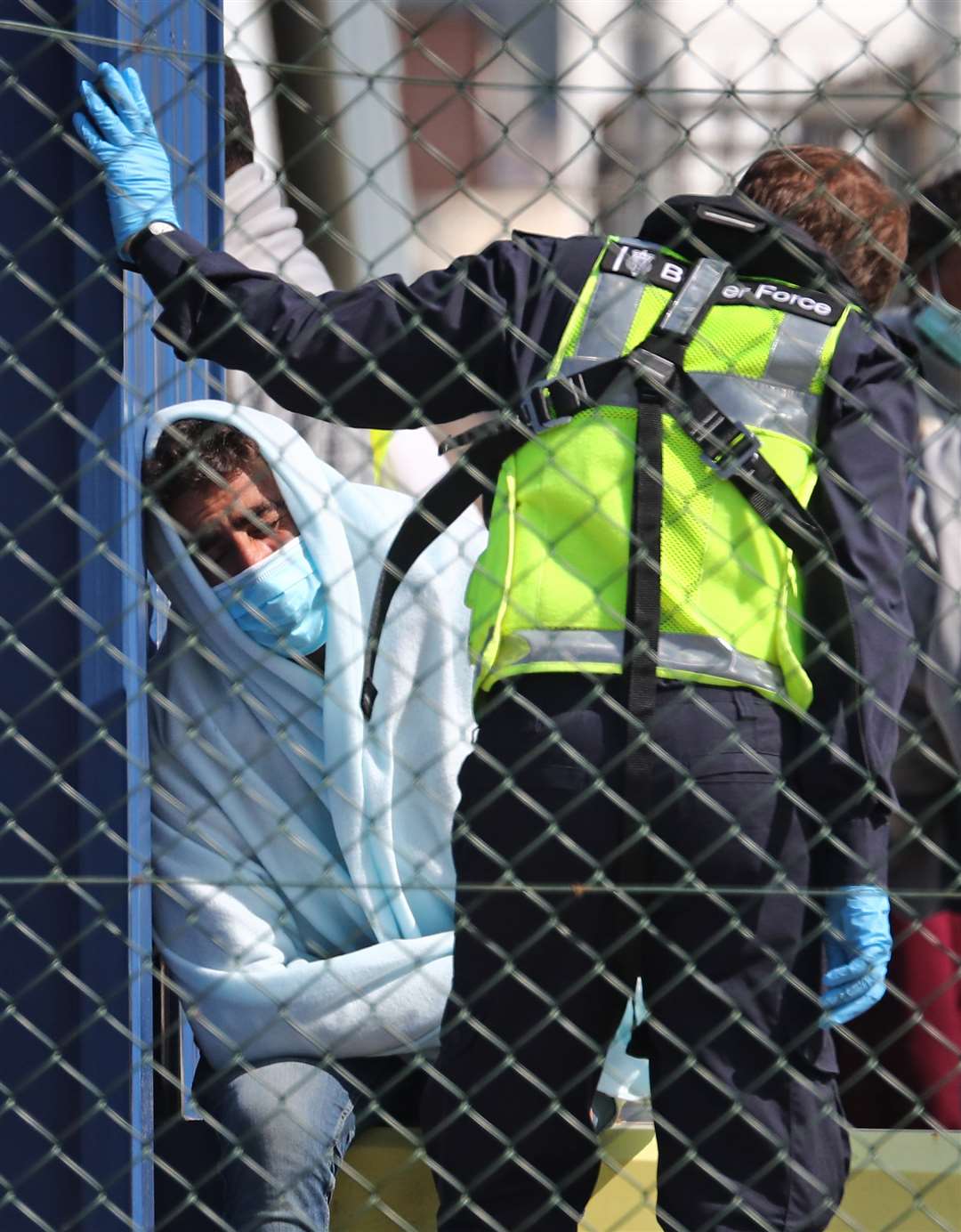 A man thought to be a migrant is processed by Border Force officers after being brought to shore in Dover (Gareth Fuller/PA)