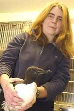 ONE OF THE LUCKY ONES: Vet Jane Hopper with William, the Guillemot, who is now well on his way to recovery at Burnham House Veterinary Surgery in Castle Street, Dover. Picture MIKE WATERMAN