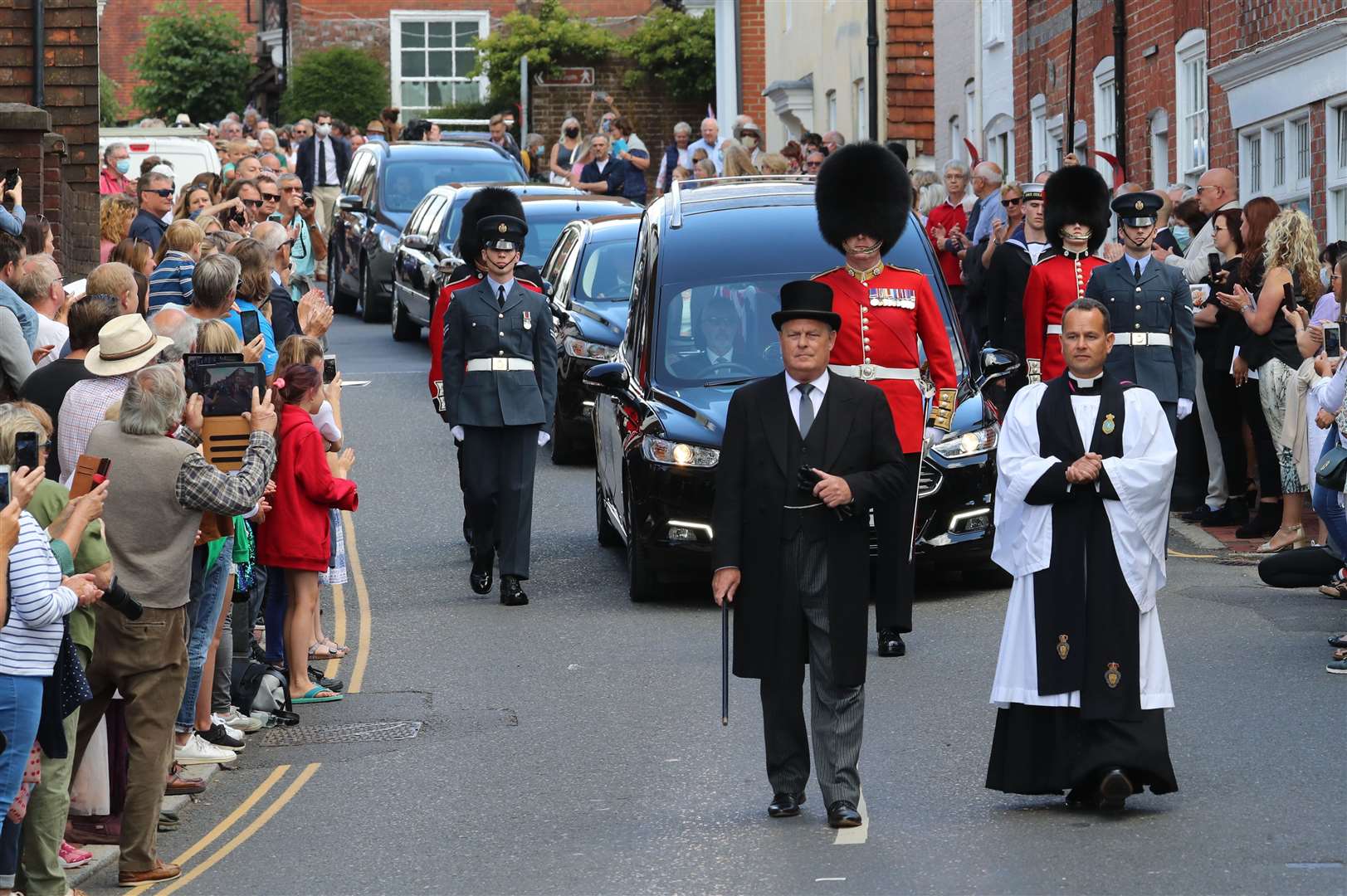 The funeral cortege of Dame Vera Lynn is escorted by representatives of the three armed forces through the village of Ditchling (Gareth Fuller/PA)