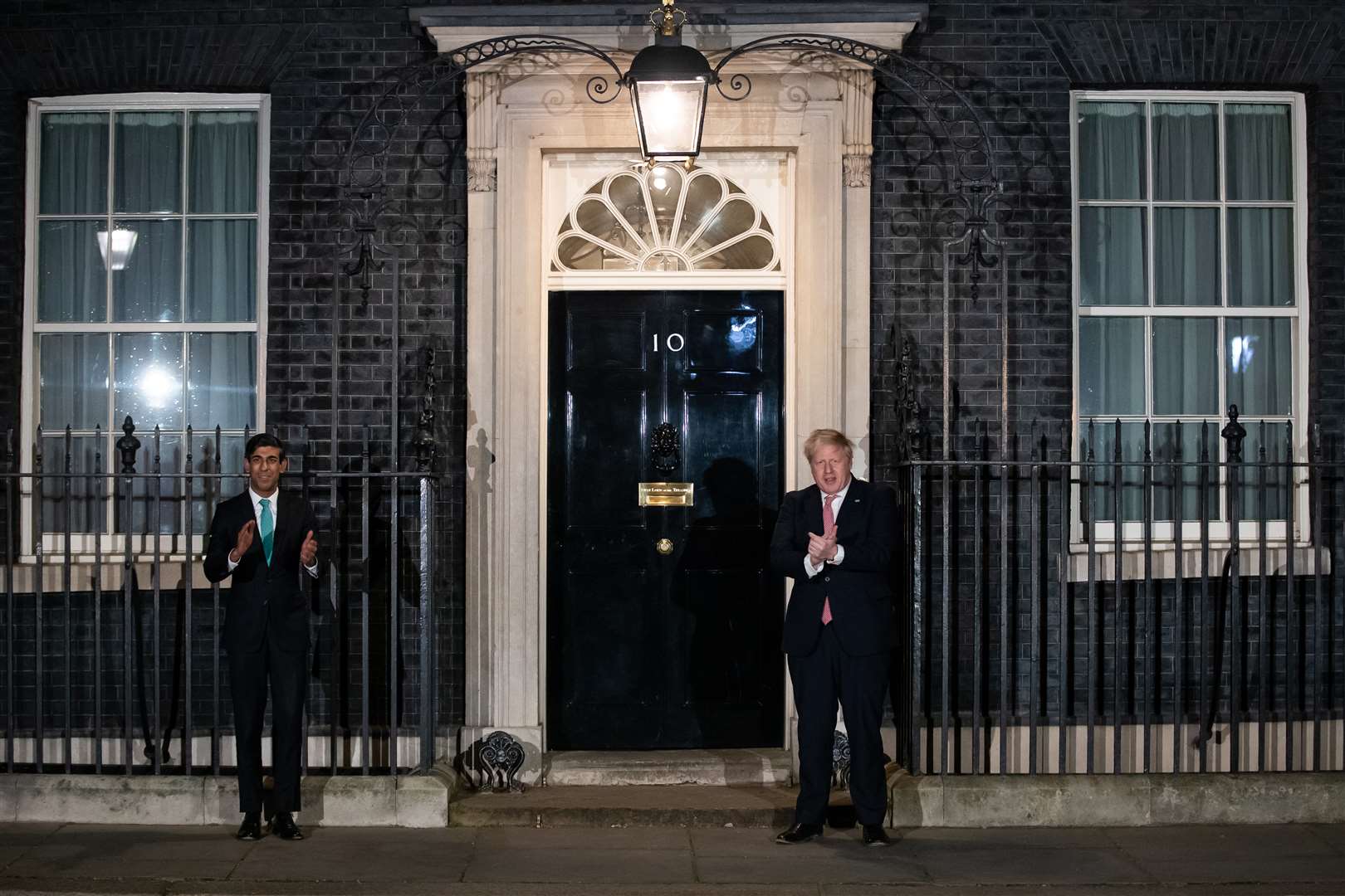 Boris Johnson and Chancellor Rishi Sunak joining in with a national applause for the NHS (Aaron Chown/PA)