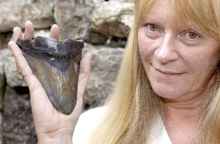 Angela Foster with the shark's tooth. Picture: JOHN WARDLEY