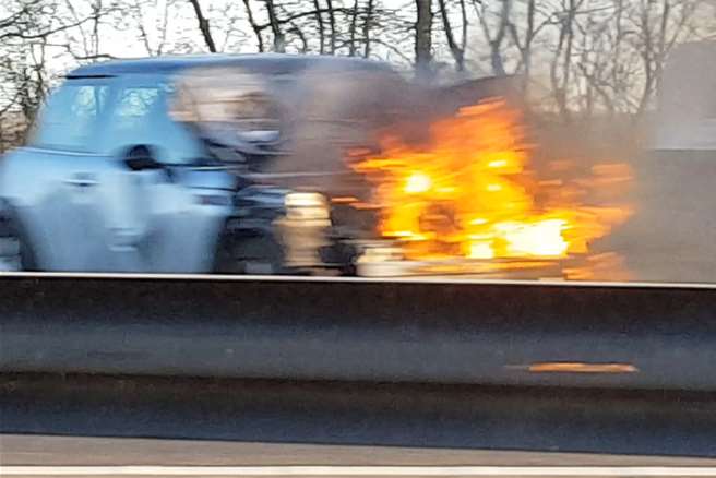 A Mini on fire on the M26. Picture: Alex Baker
