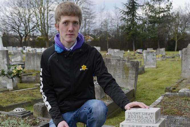 Jake Etheridge beside the unkempt grave of Flt Lt Zdzislaw Przygodzki, in Watling Street Cemetery, Dartford