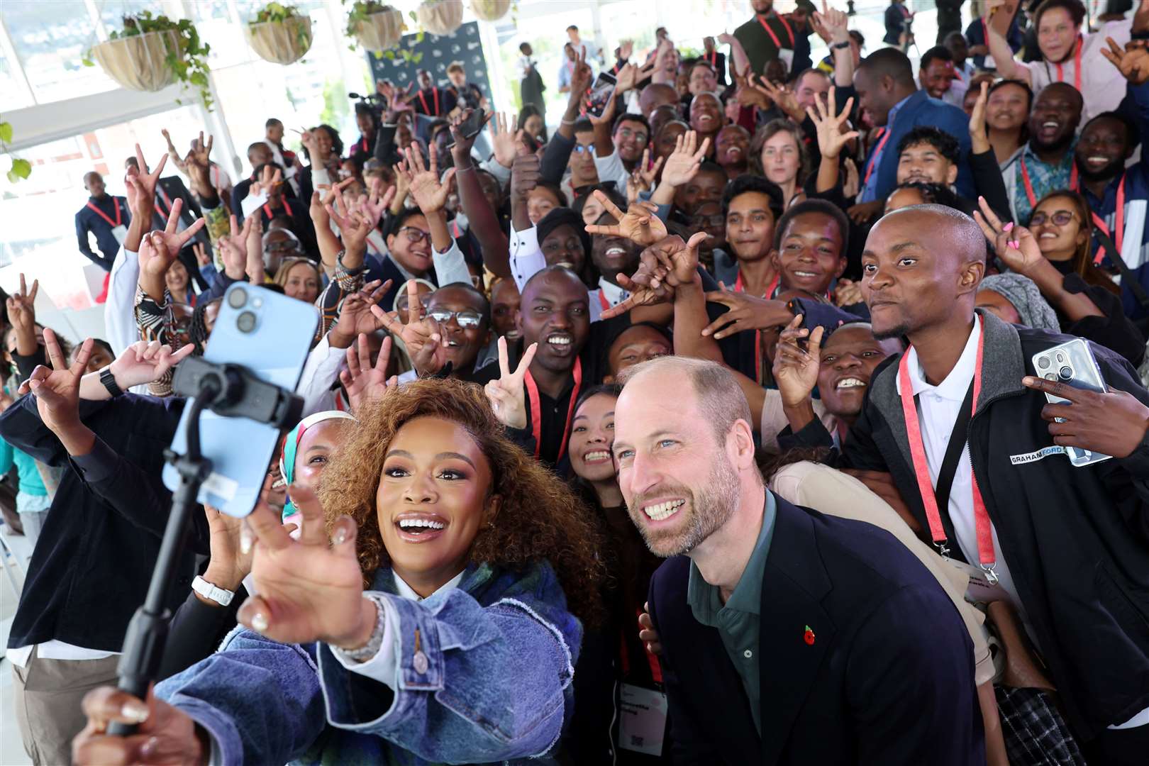 The Prince of Wales and Nomzamo Mbatha (left) pose for a selfie while meeting young environmentalists from across Africa and Southeast Asia (Chris Jackson/PA)