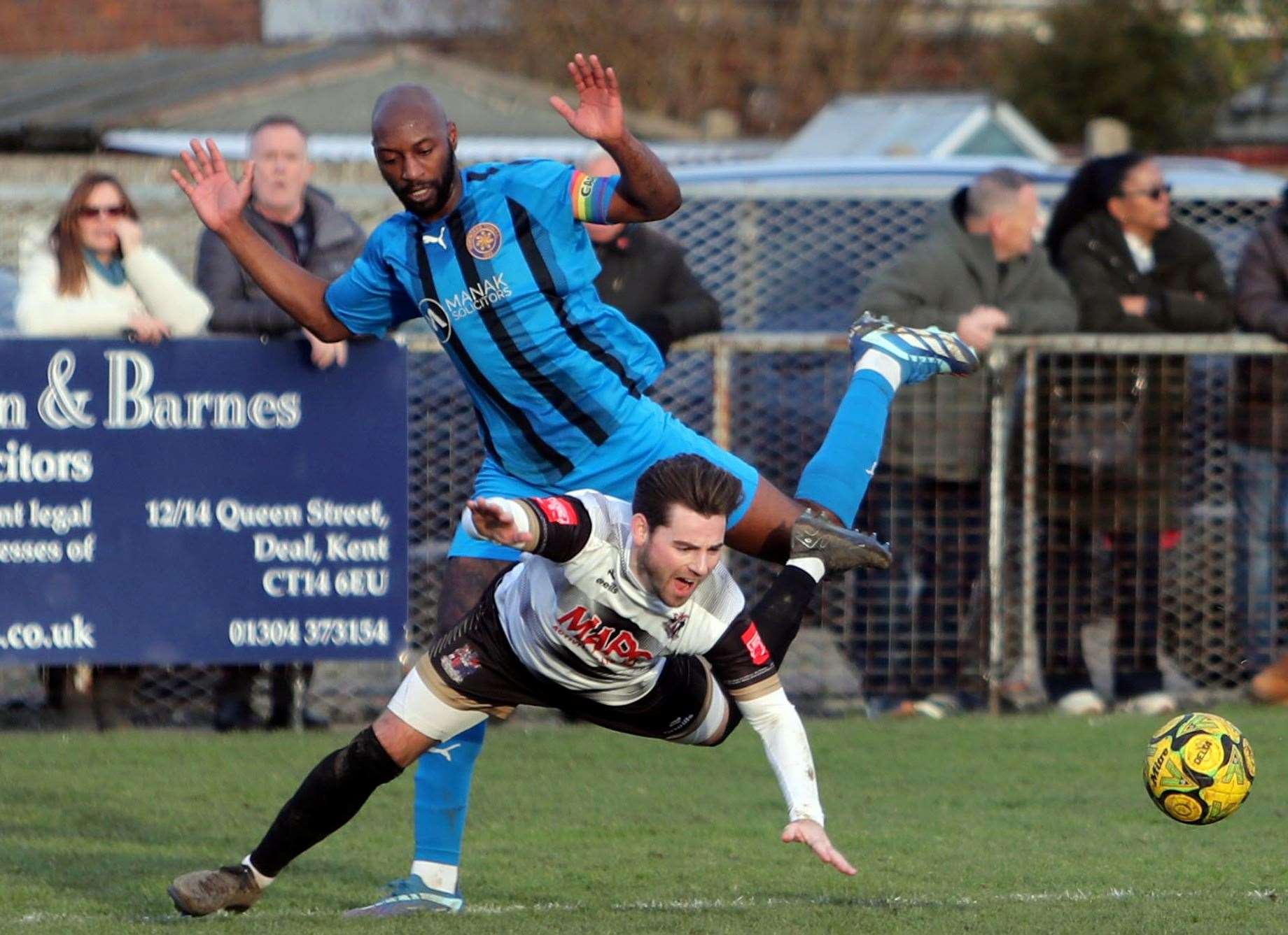 Sevenoaks skipper Jahmal Howlett-Mundle is adjudged to have fouled Deal's Ashley Miller for the penalty which Macca Murray converted in the first half. Picture: Paul Willmott