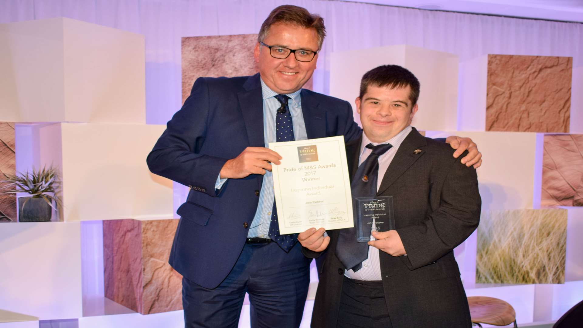 John Fletcher, right, gets his award from M&S HR director David Guise. Picture courtesy of M&S