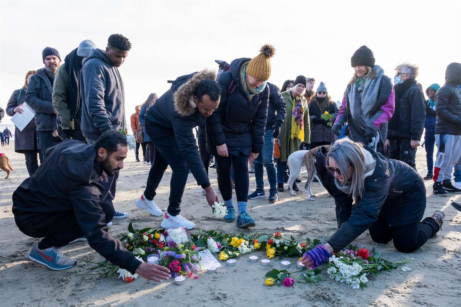 Local residents lay flowers on the sand on Sunny Sands Beach in Folkestone. Picture: Andy Aitchison.