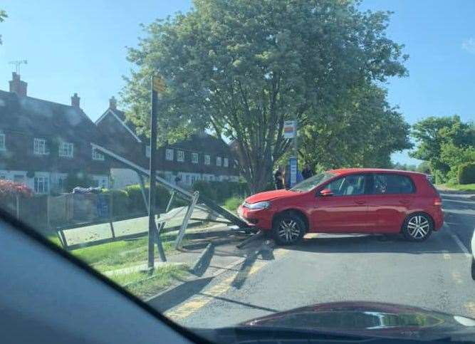 A red Volkswagen hit the bus stop