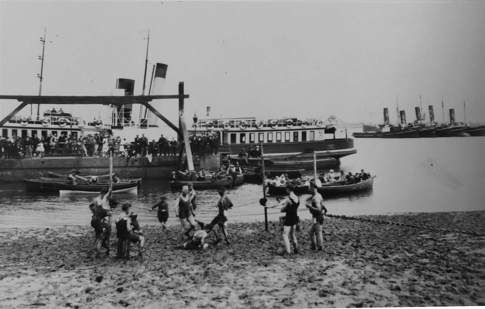 The mudlarks of Gravesend in a boxing or wrestling match on the muddy beach alongside Gravesend's Town Pier