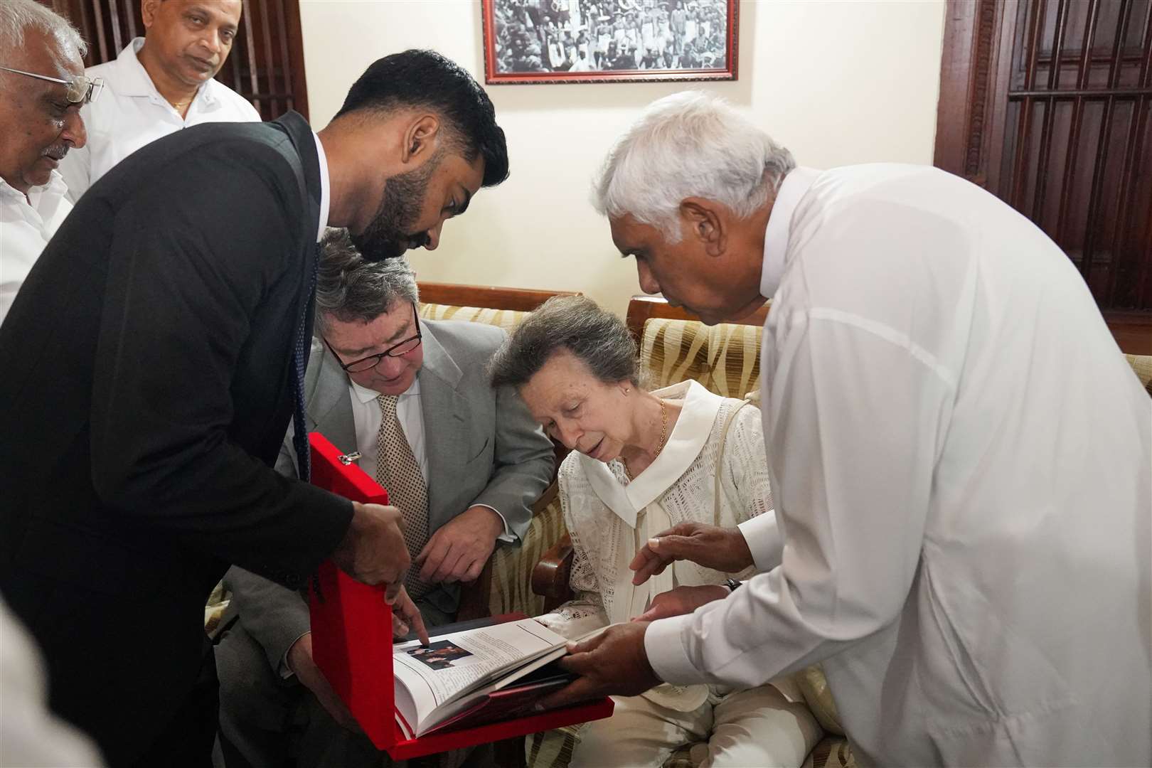 The Princess Royal and her husband Vice Admiral Sir Timothy Laurence receive a gift from acting custodian Mahinda Dela during a visit to the Temple of the Sacred Tooth Relic in Kandy (Jonathan Brady/PA)