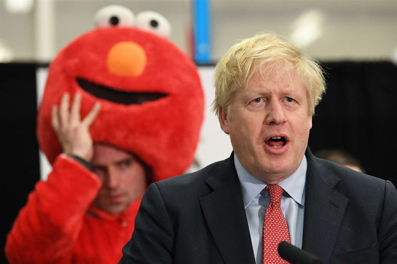 Victory achieved, Mr Johnson gives his speech in front of a fellow Uxbridge & Ruislip South candidate who was dressed as children’s TV character Elmo (PA)