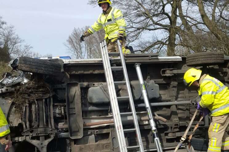 Fire crews stabilised the van while they tried to access the man trapped inside. Picture: John Pyne