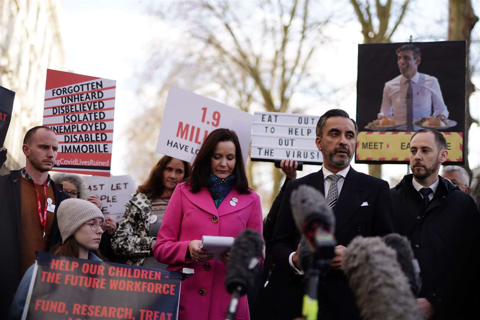 Aamer Anwar (second right), lead solicitor for the Scottish Covid Bereaved group, speaks to the media outside Dorland House in London (Jordan Pettitt/PA)