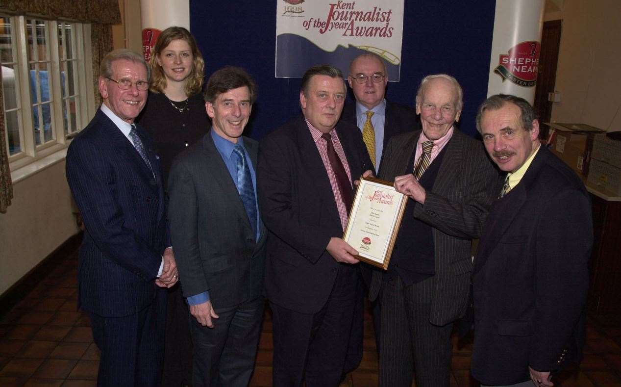 Mike Bennett in 2002 with his certificate for services to journalism, with, from left, Bob Holness, Alison Boshoff, Stuart Neame, Bob Driscoll, Lord Deedes and Martin Jackson