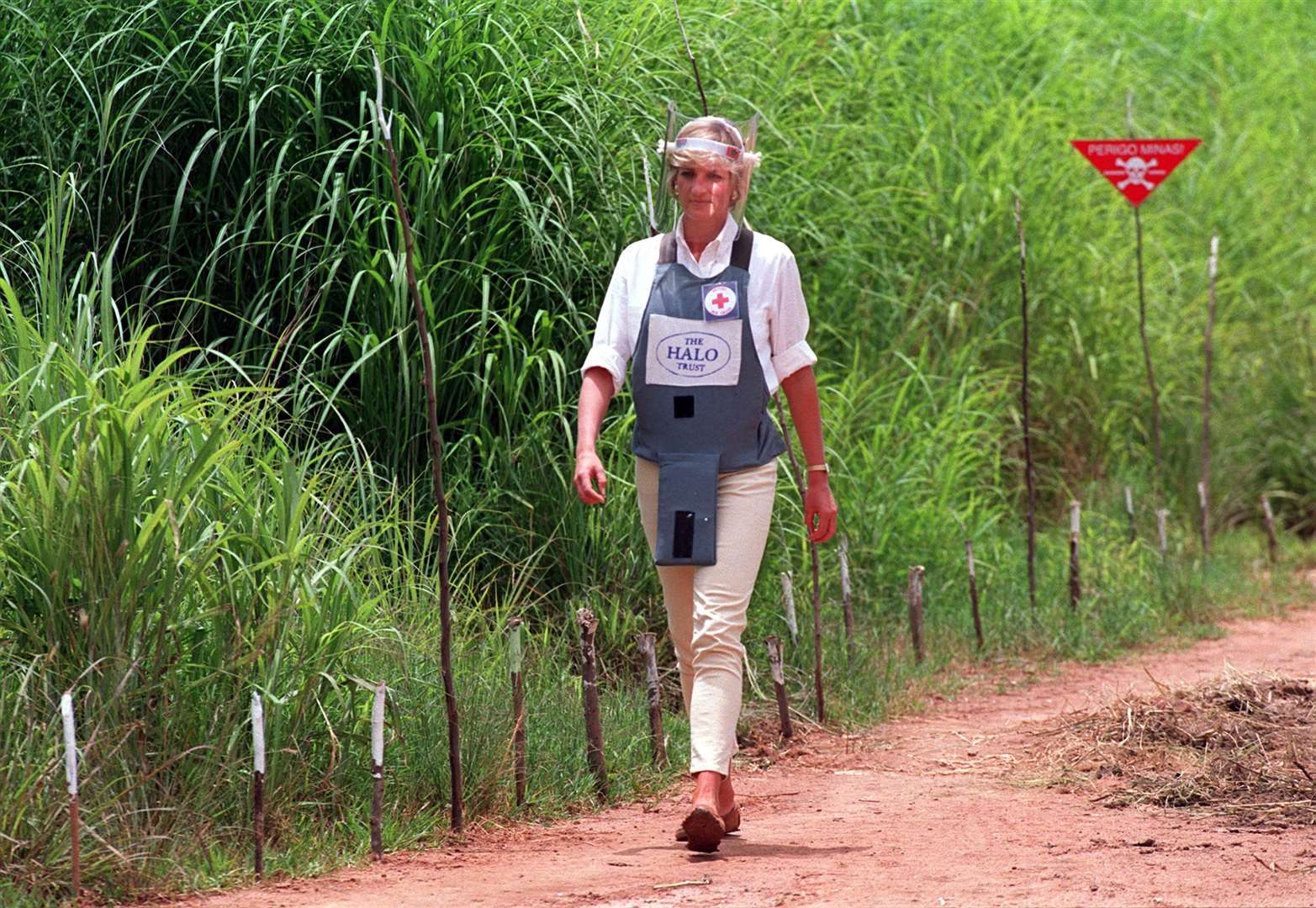 Diana, Princess of Wales, walks alongside a minefield wearing body armour during her visit to Angola in January 1997 (John Stillwell/PA)