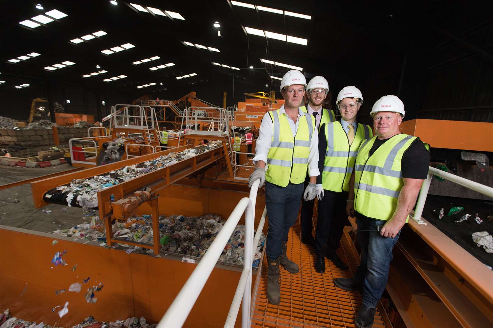 At its facility in Chatham Docks, P&D Materials co-founders David Jenner, left, and Paul Watkinson, right, flank Lloyds Bank's Liam Jolliff and Luke Ponikwer