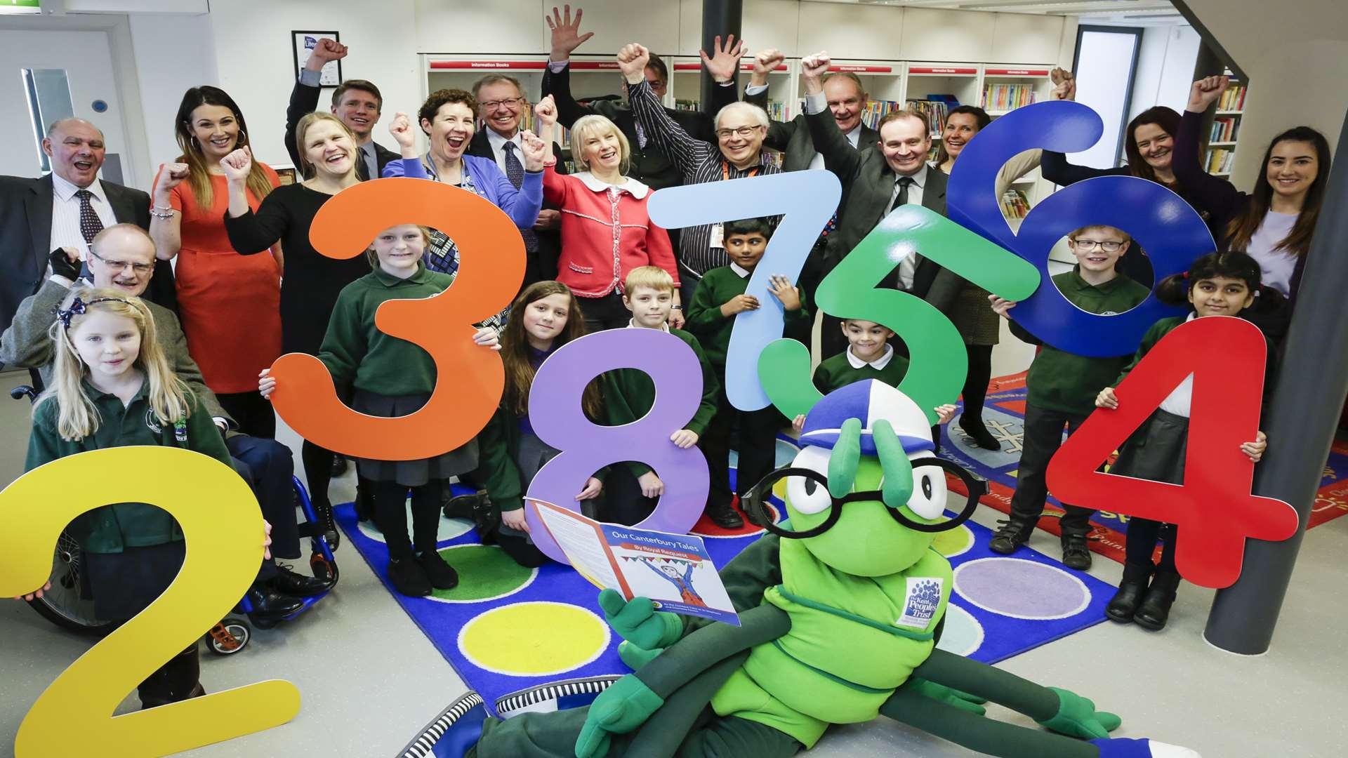 Buster Bug joined by literacy supporters and pupils from St Stephen's Juniors at the Beaney House of Art and Knowledge to announce that schools taking part in Buster's Book Club have achieved 2,387,564 minutes of reading.