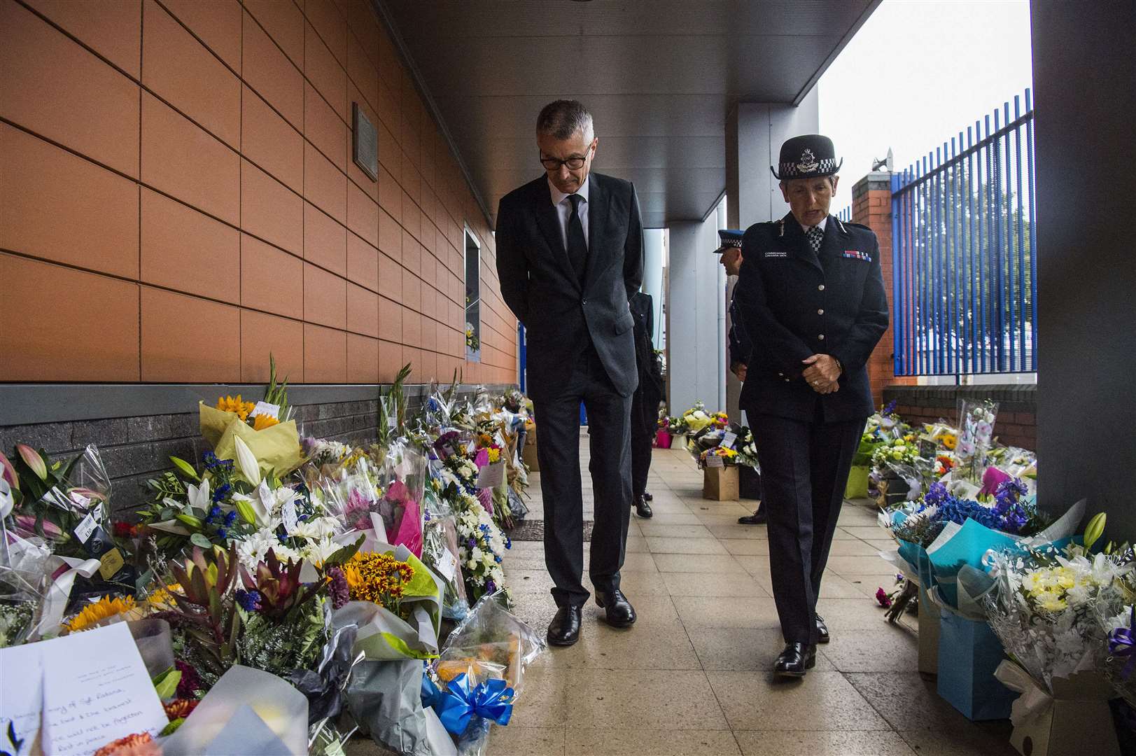 New Zealand High Commissioner to the UK Bede Corry and Metropolitan Police Commissioner Dame Cressida Dick look at tributes to Sergeant Matt Ratana at Croydon Custody Centre in south London on Thursday (Kirsty O’Connor/PA)