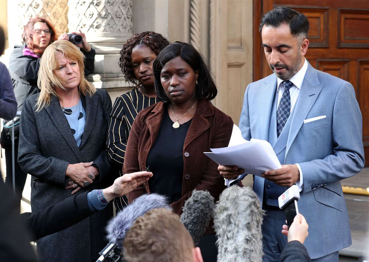 Aamer Anwar, the lawyer for the family of Sheku Bayoh, speaks to the media outside the Crown Office in Edinburgh alongside Kadijatu Johnson (third left) and Adama Jalloh sisters of Sheku Bayoh and Deborah Coles, Director of Inquest (Andrew Milligan/PA)