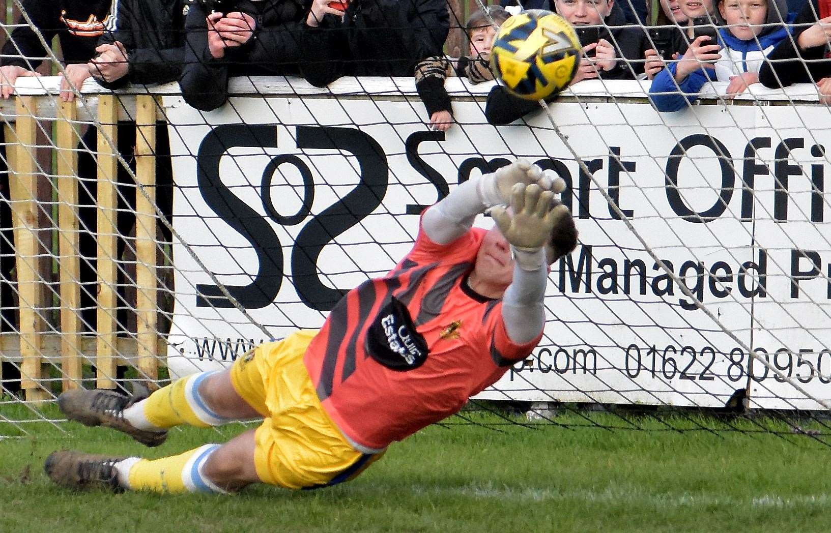 Stand-in keeper Harrison Pont saves Adebayo Akinfenwa's late penalty. Picture: Randolph File