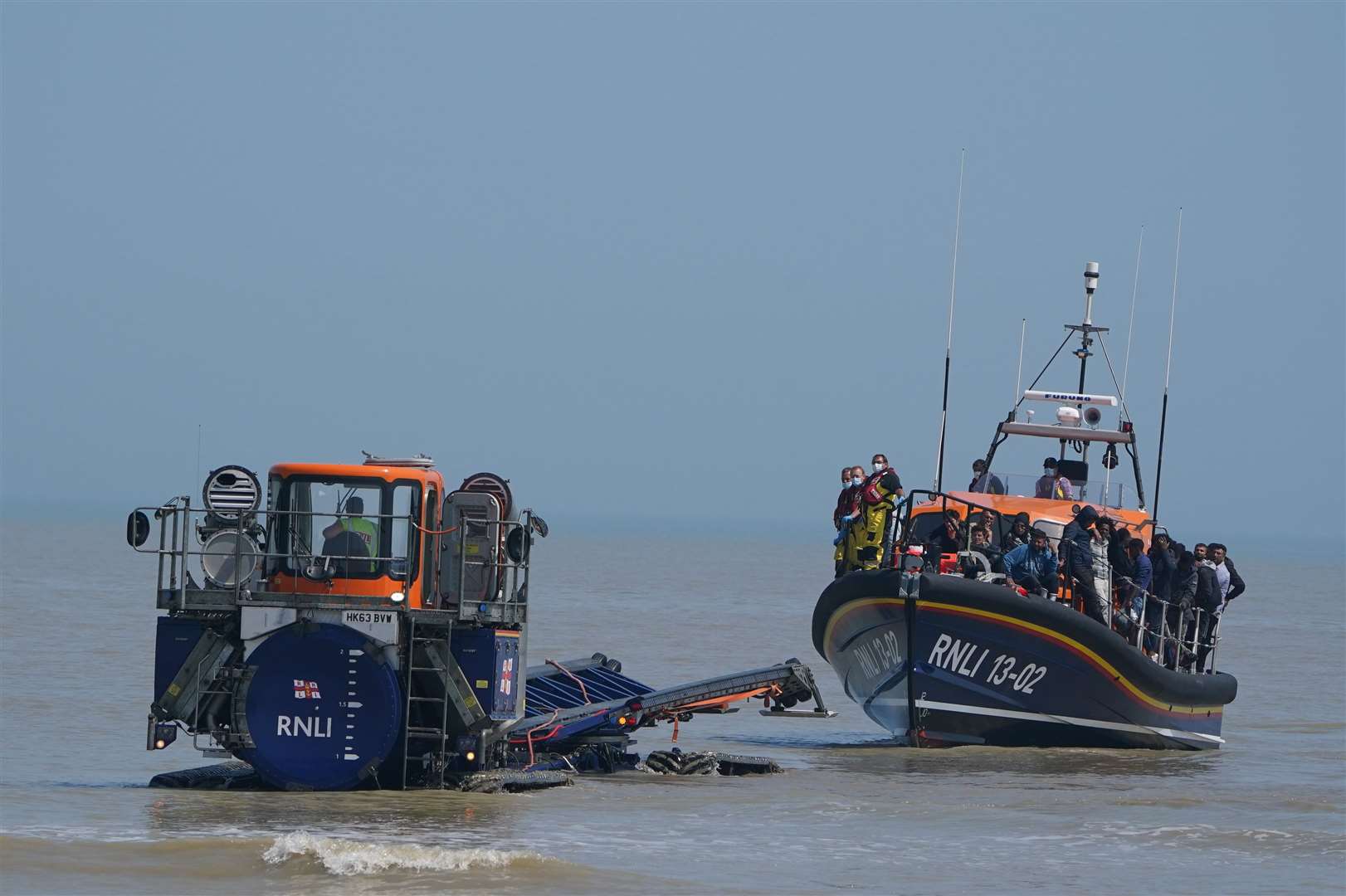 A shore recovery tractor tows the Dungeness lifeboat to the beach after it returned carrying people crossing from France (Gareth Fuller/PA)