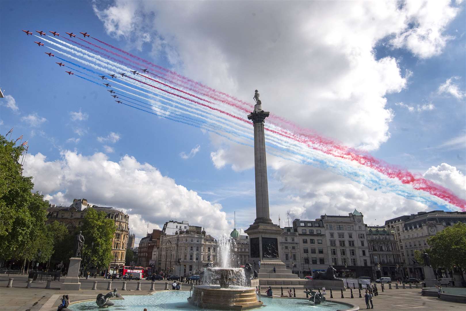 The Red Arrows and their French equivalent, La Patrouille de France fly over Nelson’s Column in Trafalgar Square (Victoria Jones/PA)