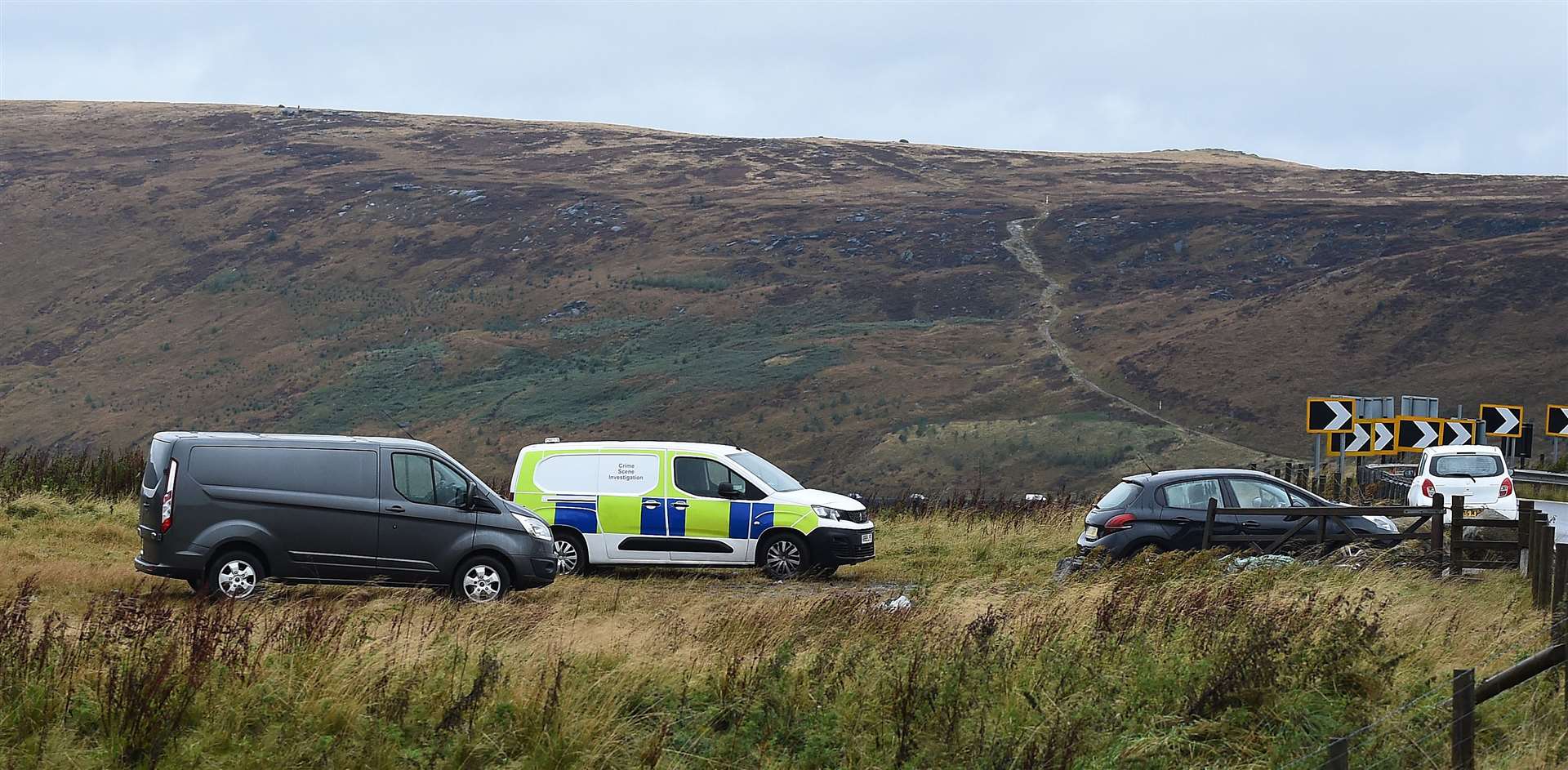 Vehicles parked near the search area on Saddleworth Moor, in north west England (Peter Powell/PA)