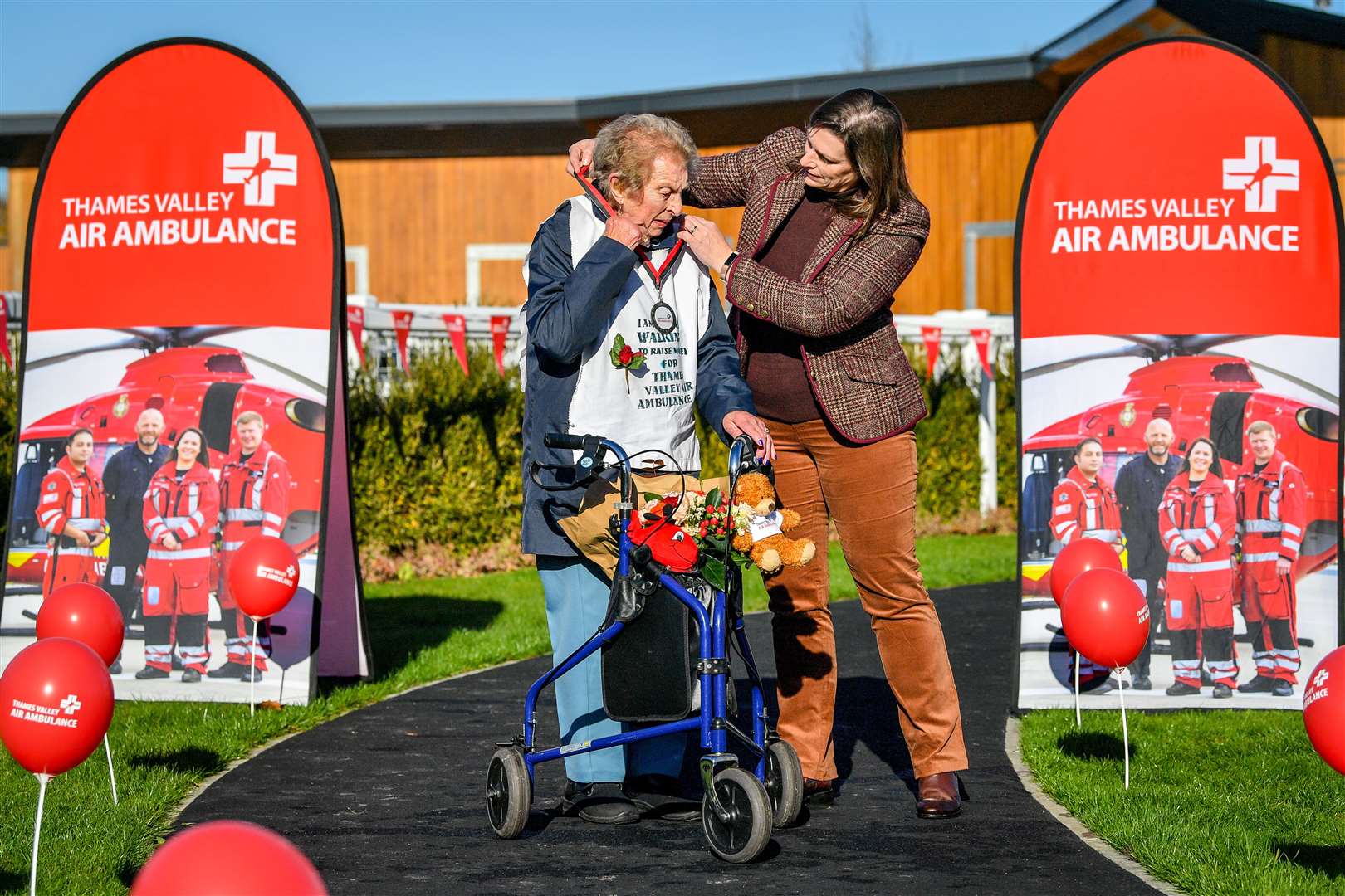 Ruth Saunders is presented with a medal from Thames Valley Air Ambulance by her granddaughter Kate Saunders (Ben Birchall/PA)