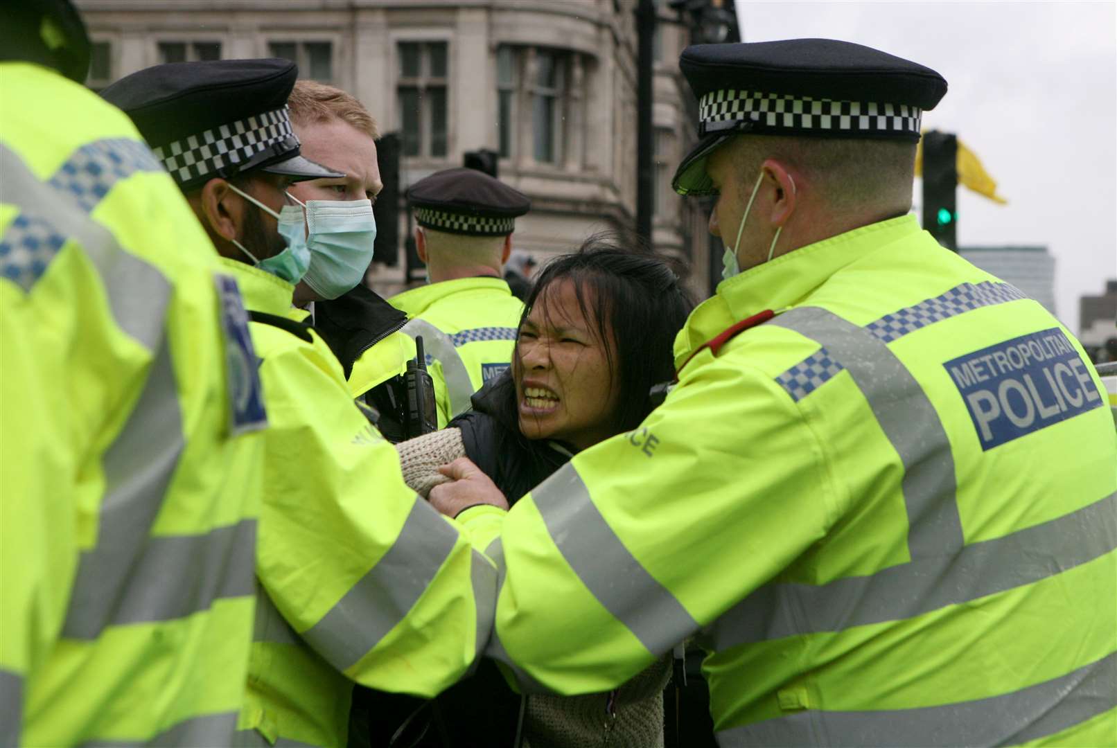 A protester is led away by police officers (Luciana Guerra/PA)