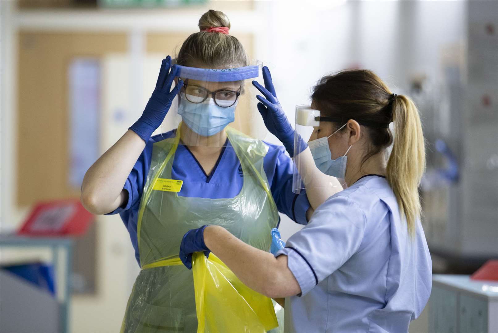 Nurses change their PPE as they prepare to go back into battle on a Covid red ward (Jane Barlow/PA)