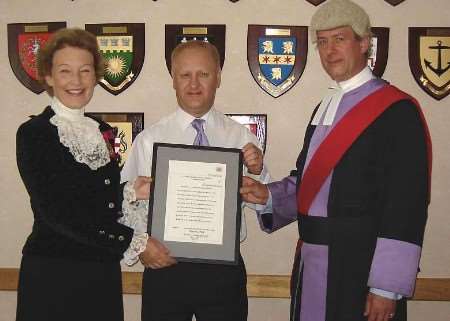 Ken Graham receiving his bravery award at Maidstone Crown Court from Judge Michael Lawson, QC, and High Sheriff Amanda Cottrell. Picture: TOM NEWFIELD