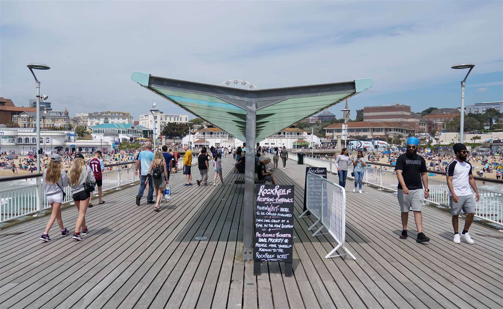 A sunny stroll along Bournemouth pier (Andrew Matthews/PA)