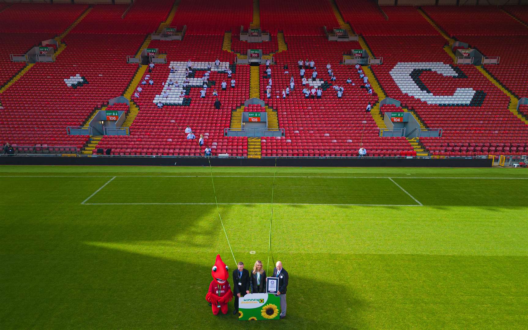 Christine McGuinness with Hidden Disabilities Sunflower chief executive Paul White (second left) and Guinness World Record adjudicator Glenn Pollard (right) (Stratus Imagery/PA)